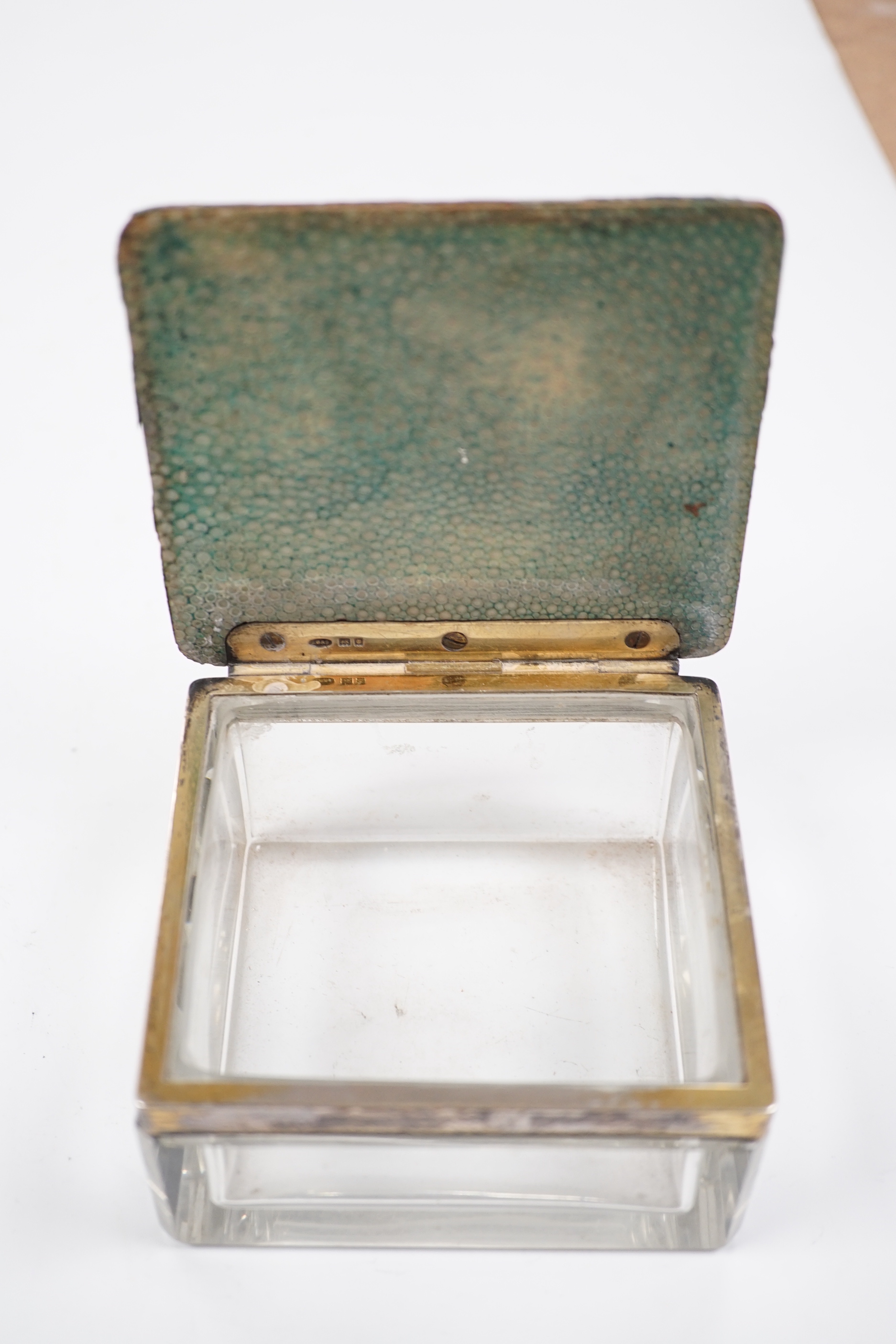 A George V silver and shagreen mounted glass square toilet box, with hinged cover, by George Betjemann & Sons Ltd, London, 1927, retailed by Asprey, London, width 94mm.